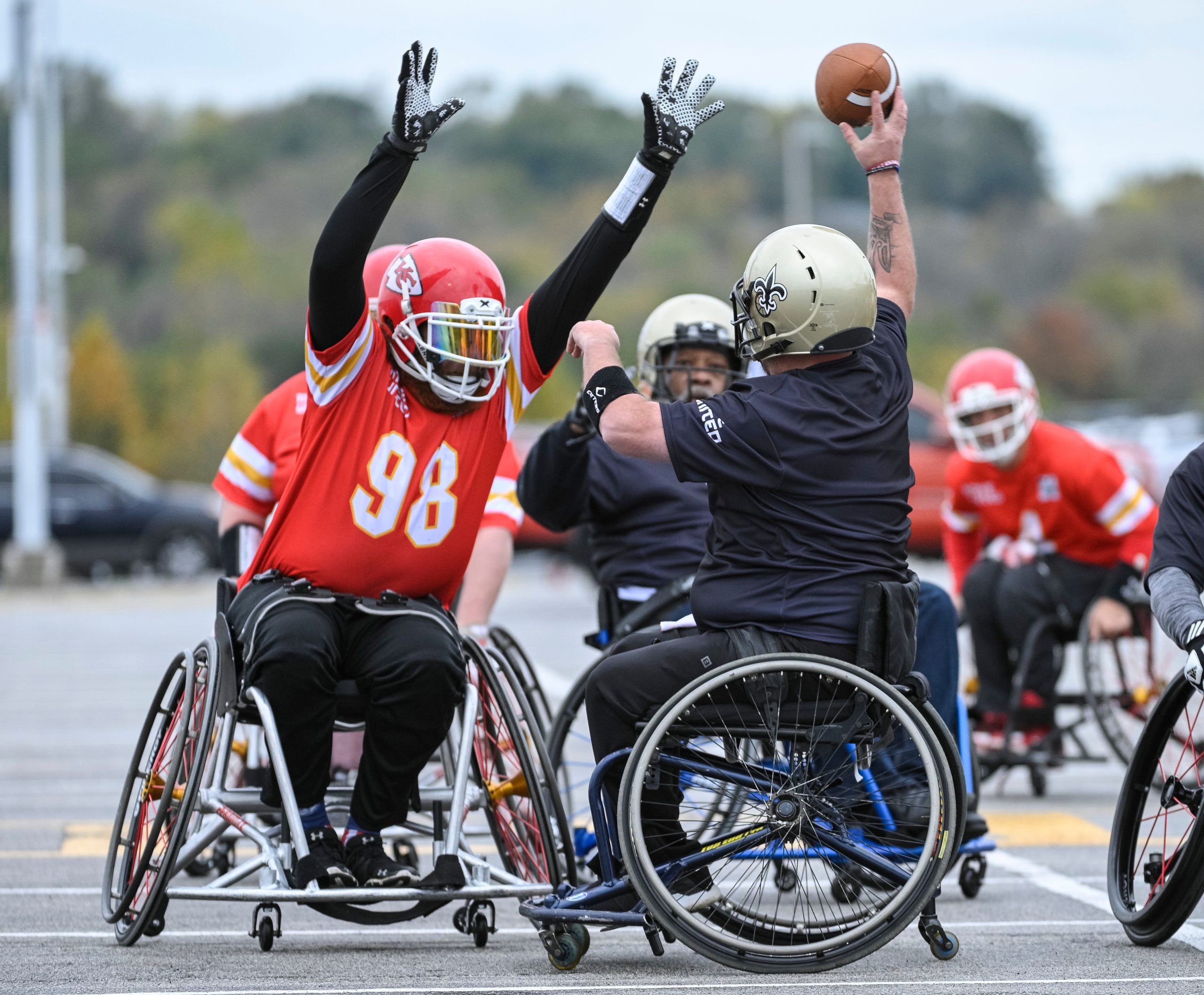 Kansas City Chief tries to block a New Orleans athlete